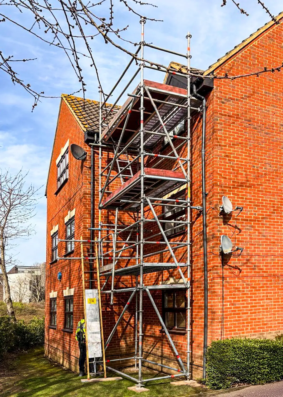 Access tower scaffold installed against a residential property in Milton Keynes for roof inspection