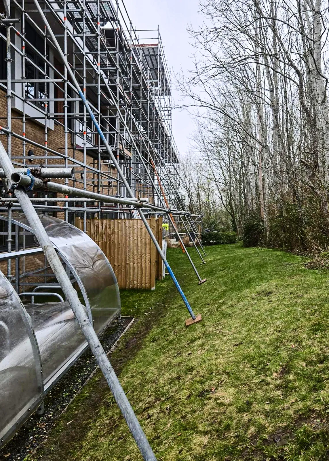 Independent scaffold installed along a residential block in Kent’s Hill for solar installation and gutter access